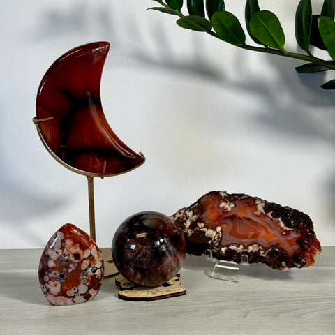 Kenna's Imperfect Bundle: Red agate moon, orb, and raw crystal slice with white and brown patterns.