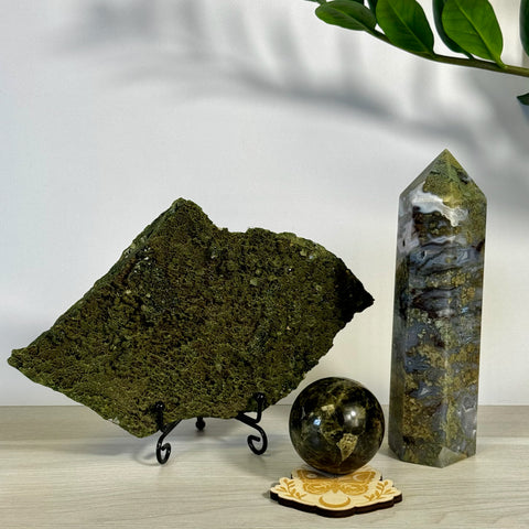 Kenna's Stylized Imperfect Bundle: Green mossy crystal slab, dark green sphere, and tall moss agate tower.