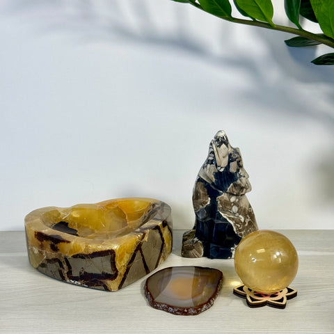 Kenna's Stylized Imperfect Bundle: Heart-shaped onyx bowl, black & white crystal wolf, yellow crystal sphere, and brown agate slice.