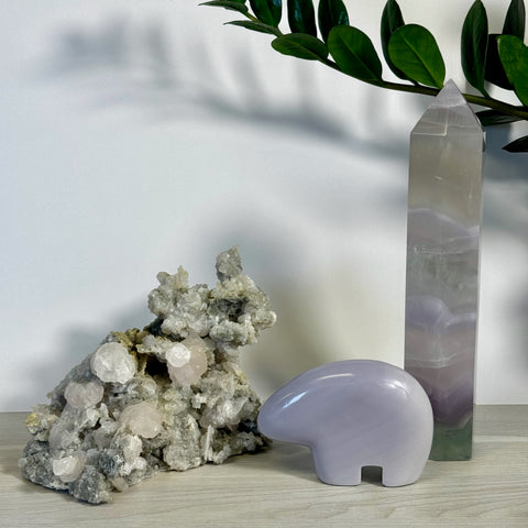 Kenna's Stylized Imperfect Bundle with a tall purple crystal tower, a light grey crystal bear, and a raw cluster of white and pink crystals.