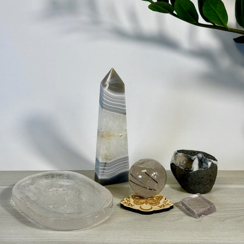 Kenna's Stylized Imperfect Bundle: Clear crystal dish, banded agate tower, tourmalinated quartz sphere, raw geode, and pink crystal.