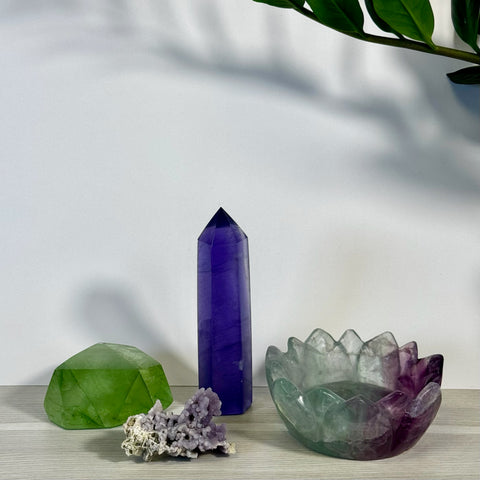 Kenna's Stylized Imperfect Bundle: Green, purple, and clear crystals, including a faceted stone, tower, raw cluster, and lotus bowl.