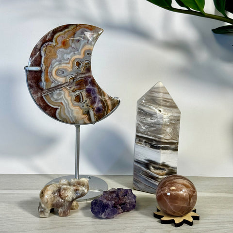 Kenna's Stylized Imperfect Bundle: Moon-shaped agate, crystal tower, elephant carving, amethyst cluster, and sphere.