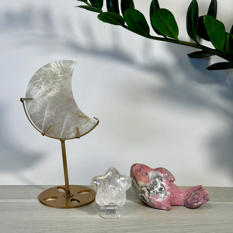 Kenna's Stylized Imperfect Bundle: Iridescent moon crystal on gold stand, clear star, and pink dolphin crystal.