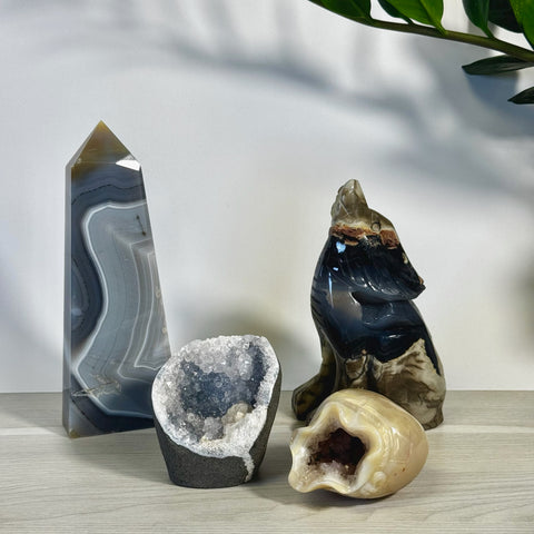 Kenna's Stylized Imperfect Bundle: Gray agate tower, geode, and howling wolf carving with a small tan geode.