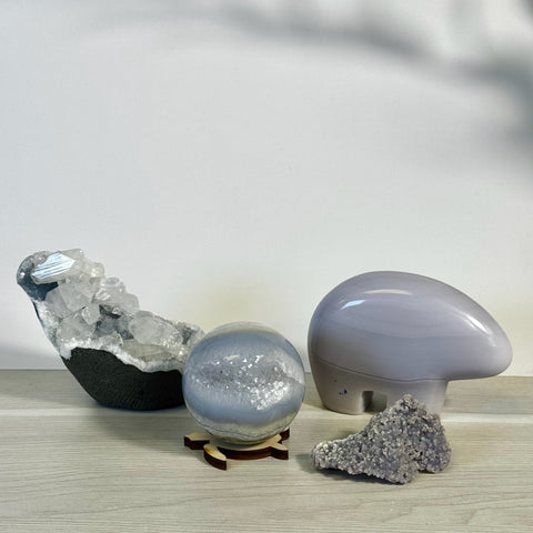 Kenna's Stylized Imperfect Bundle: Geode, crystal sphere on wood stand, smooth gray stone, and purple druzy.