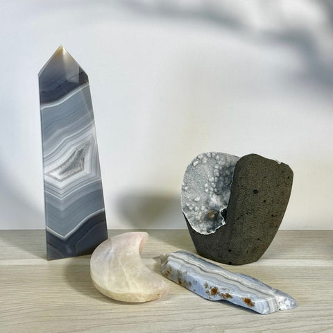 Kenna's Stylized Imperfect Bundle S2: Grey agate obelisk, pink moon, blue striped crystal, and dark geode.