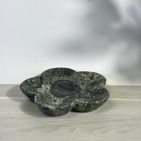 Kiwi Fossil Flower Plate: Dark green fossilized stone dish with a unique five-petal flower shape.