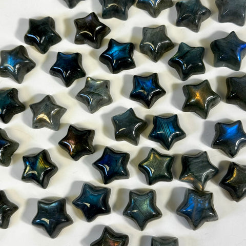 Mini labradorite star carvings with iridescent blue and gold flashes.