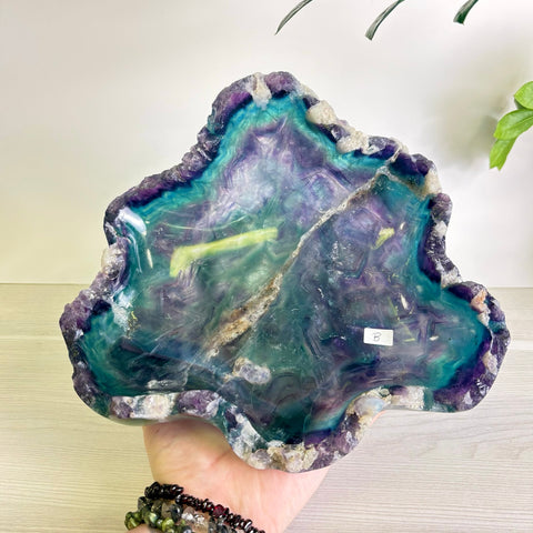Hand-carved Mystic Mountain bowl made of polished purple and teal fluorite with raw, natural crystal edges.