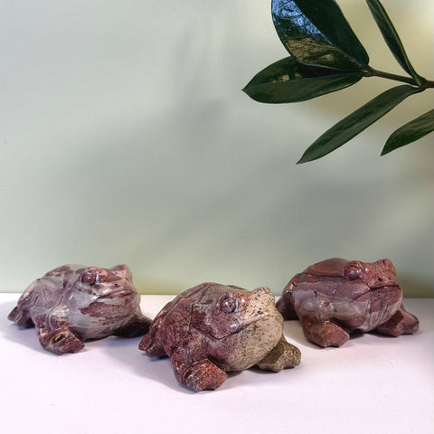 Three unique red and beige marbled painting stone frog figurines.