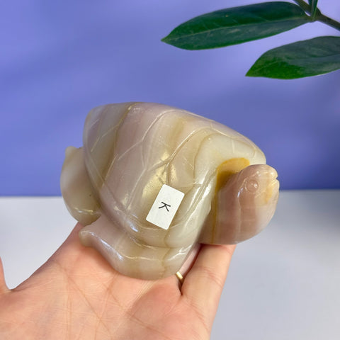 Pink banded onyx turtle carving with K variant label.