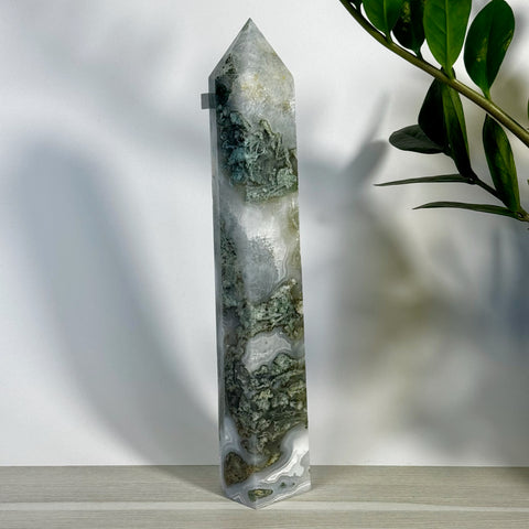 Tall, polished moss agate tower with white, grey, and deep green natural patterns.