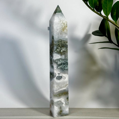Tall, polished moss agate tower with white, grey, and green natural patterns.