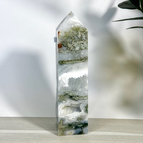 Tall, polished moss agate tower with white, grey, and green natural patterns, pointed top.