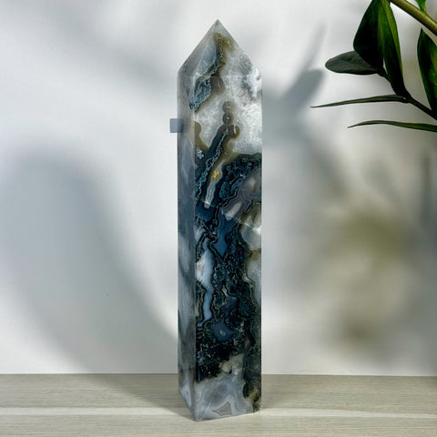 Tall, polished moss agate tower with white, grey, and dark green natural patterns.