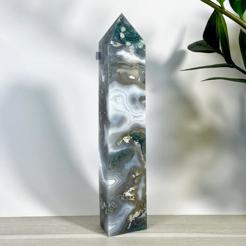 Tall, polished moss agate tower with white, grey, and deep green swirling patterns.