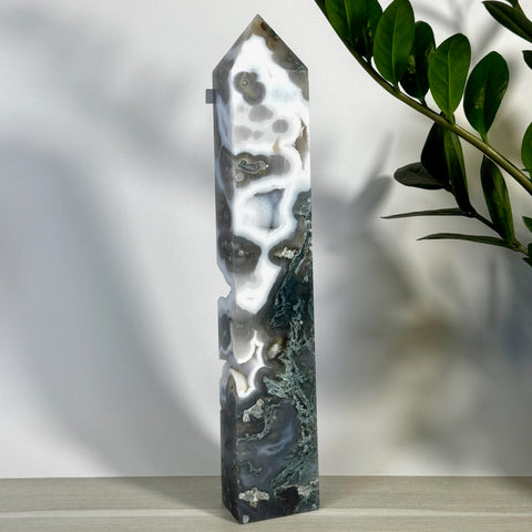 Tall, polished moss agate tower with striking white, gray, and deep green natural patterns.