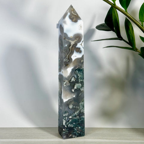 Tall, polished moss agate tower with white, gray, and deep green swirling patterns.