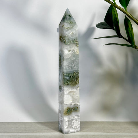 Tall, polished moss agate tower with white, grey, and green swirling patterns, pointed top.