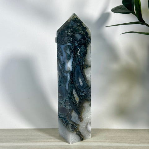 Tall, polished moss agate tower with striking dark green, white, and grey natural patterns.