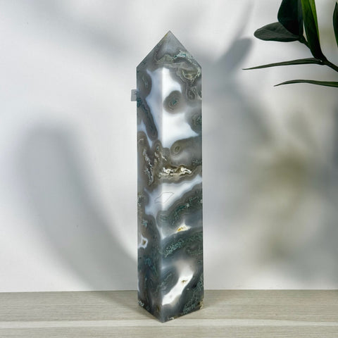Tall, polished moss agate tower with white, gray, and green swirling patterns.