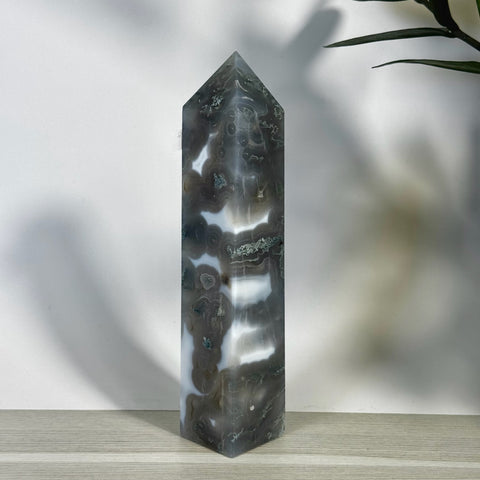 Tall, polished moss agate tower with striking grey, white, and green natural patterns.