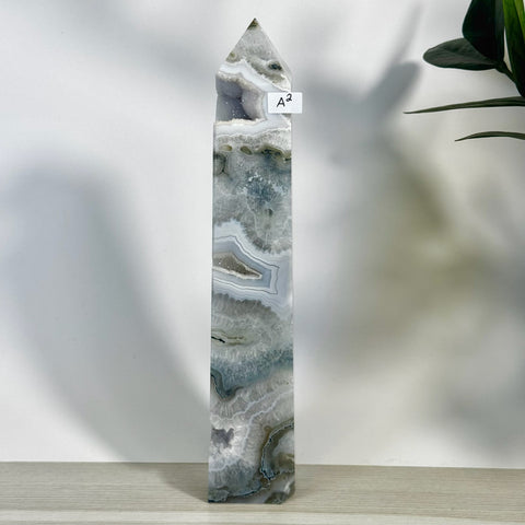 Tall, polished moss agate tower (A2) with intricate grey, white, and clear natural patterns.