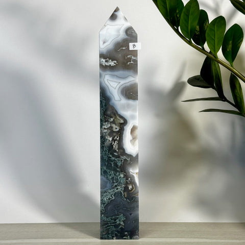Tall, polished moss agate tower (variant B) with striking white, gray, and deep green natural patterns.