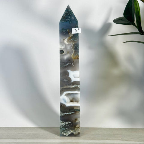 Tall, polished moss agate tower (D2) with intricate gray, white, and green natural patterns.