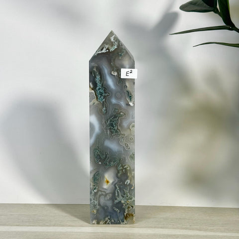 Tall, polished moss agate tower (E2) with intricate green, white, and gray patterns.
