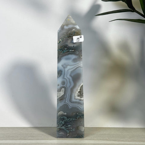 Tall, polished moss agate tower (H2) with gray, white, and green swirling patterns and a pointed top.