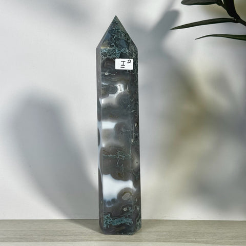 Tall, polished moss agate tower with dark green, grey, and white swirling patterns.