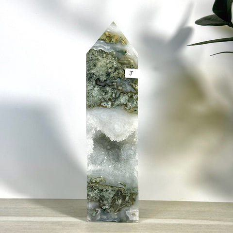 Green and white moss agate tower (variant J) with a sparkling geode cavity.