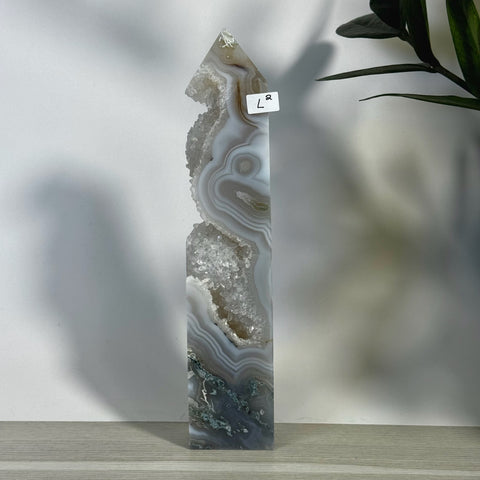 Tall L2 moss agate tower with natural grey, white, and green banding, featuring sparkling druzy crystal pockets.