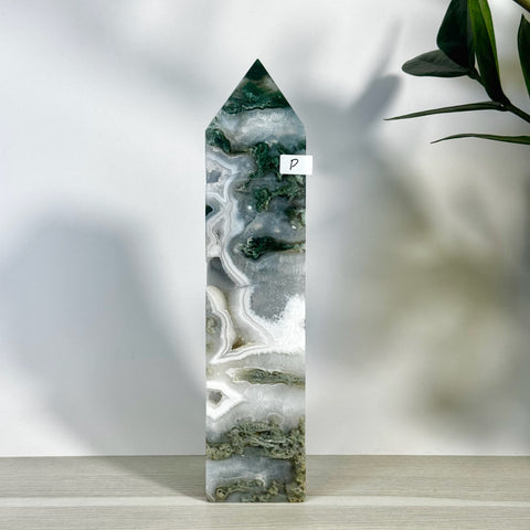 Tall moss agate tower with white, grey, and deep green natural patterns, pointed top.