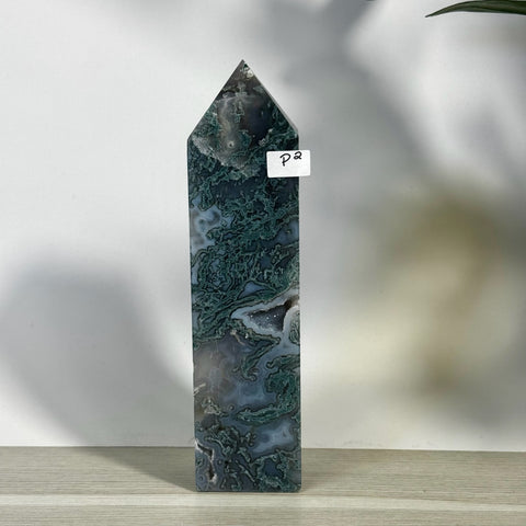Tall, polished moss agate tower with deep green and white swirling patterns, featuring a small geode inclusion.