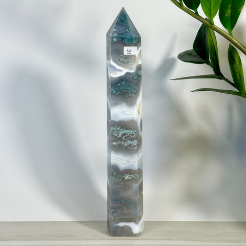 Tall, polished moss agate tower with white, gray, and green swirling patterns.
