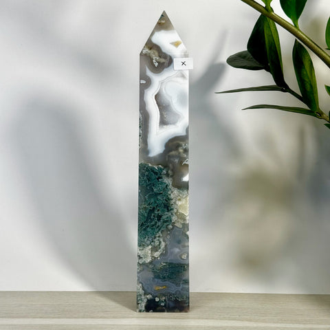Tall, polished moss agate tower with white, grey, and deep green natural patterns.