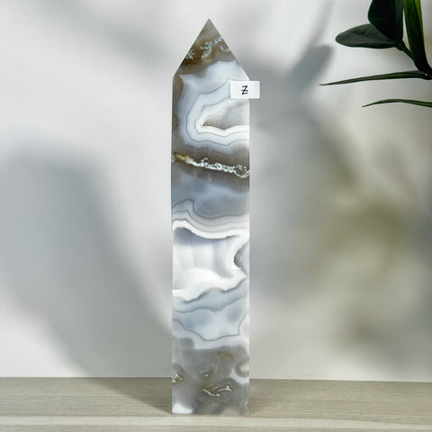 Tall, polished moss agate tower (variant Z) with swirling grey, white, and brown patterns.