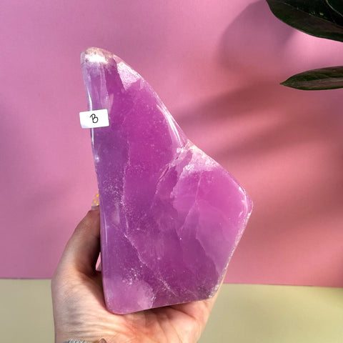 Statement Pink Aragonite Free Form crystal, variant B, held in hand.