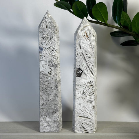 Two tall, pointed white lace agate towers with intricate gray and white patterns.