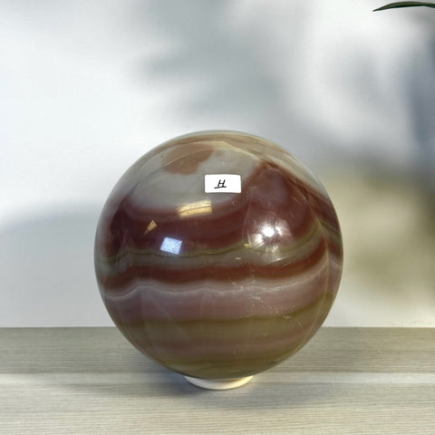 XL pink banded onyx sphere with natural red, white, and green color variations.